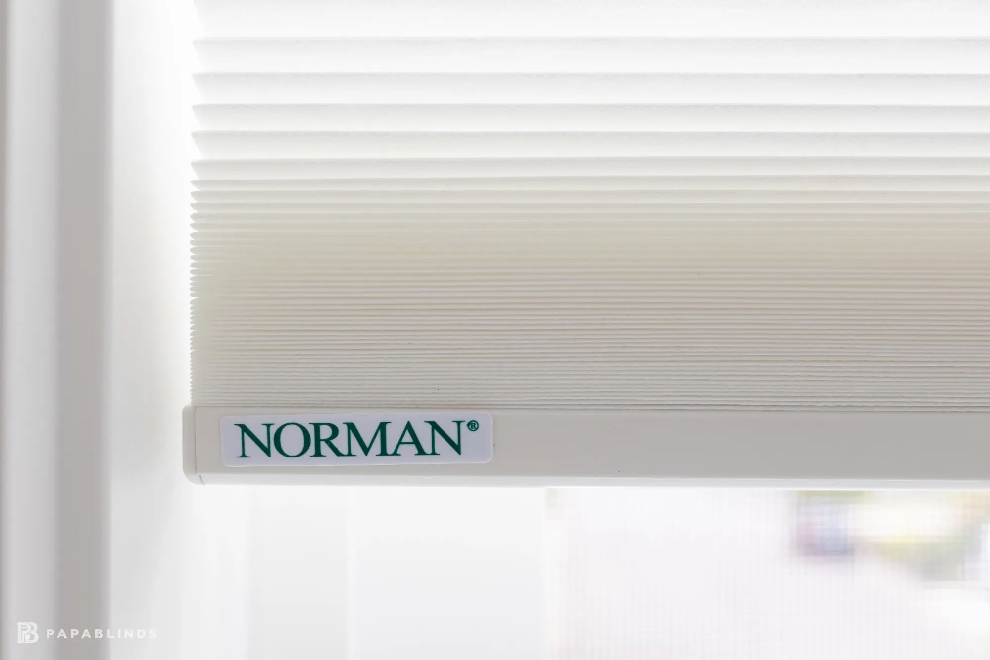 Norman label on the bottom rail of a white cellular shade