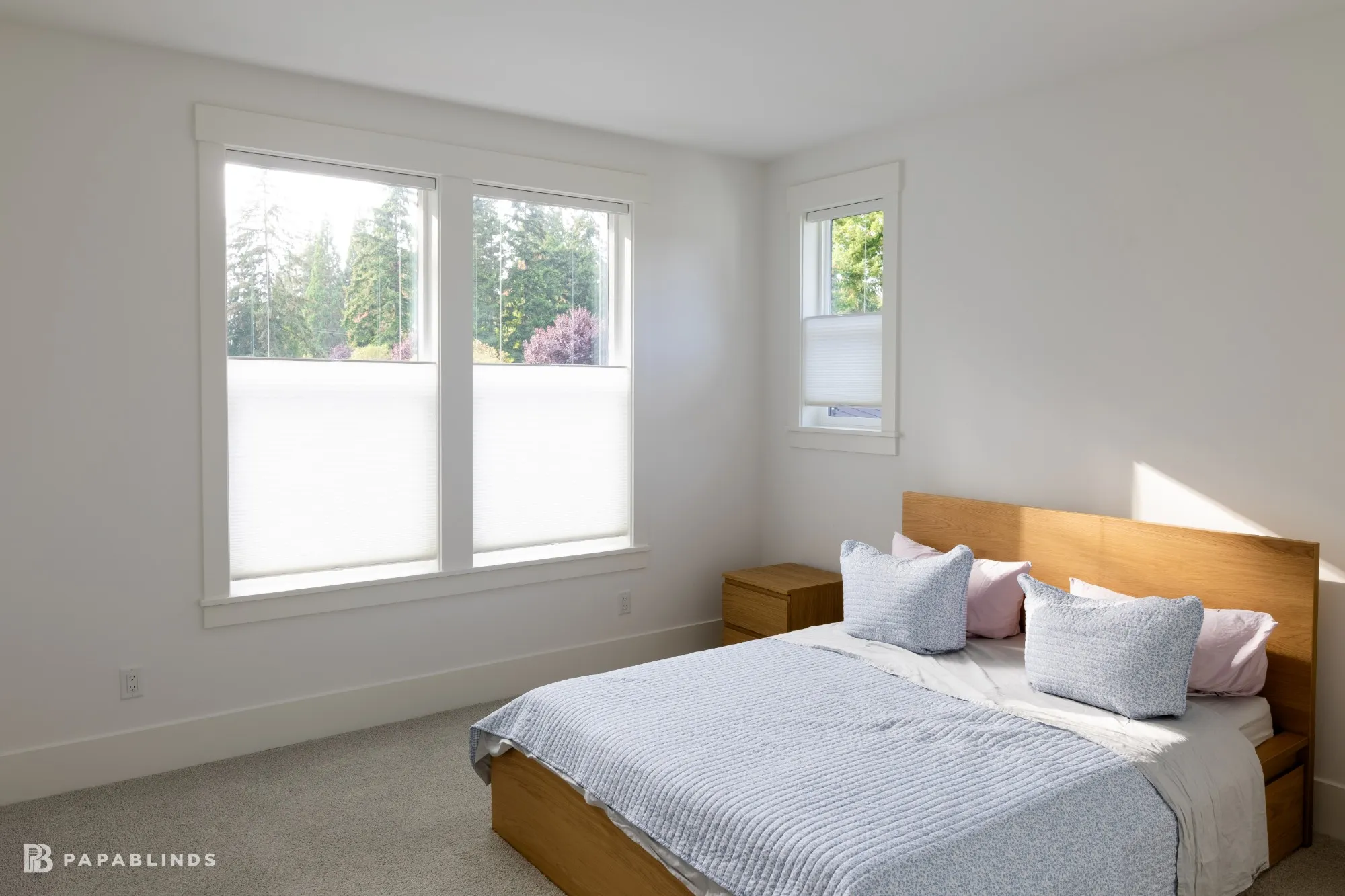 Bedroom with a double window and a small side window fitted with white top-down bottom-up cellular shades